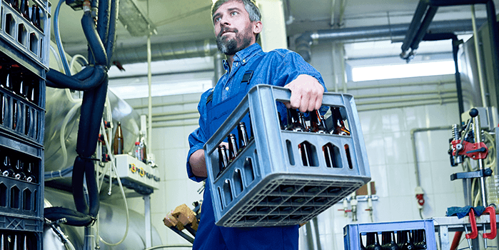 Homem carrega caixa de cerveja